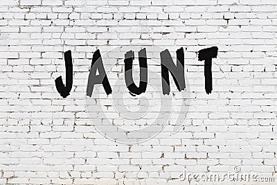 Word jaunt painted on white brick wall Stock Photo