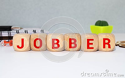 money jobber - the word was printed on a metal bar. the metal bar was placed on several banknotes Stock Photo