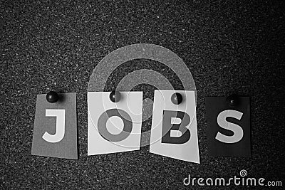 The word Jobs written on colorful note papers on board background. Employment concept. Job search Stock Photo