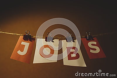 The word Jobs written on colorful note papers on board background. Employment concept. Job search Stock Photo