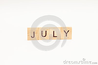 Word JULY made of wooden blocks on white background. Month of year Stock Photo