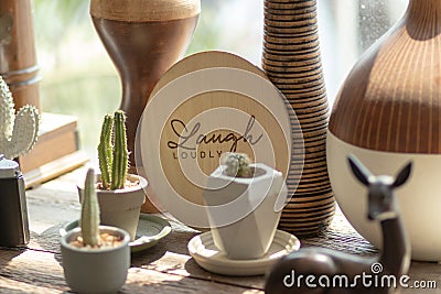 The word LAUGH LOUDLY was printed on circular wooden background Stock Photo