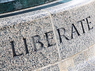 The Word LIBERATE in Stone Stock Photo