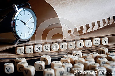 Word: linguistics next to letters, wristwatch and notepad. The concept of scientific research in linguistics and the history of Stock Photo