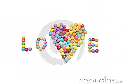 Word ``Love`` and abstract heart from bright colorful candy Stock Photo