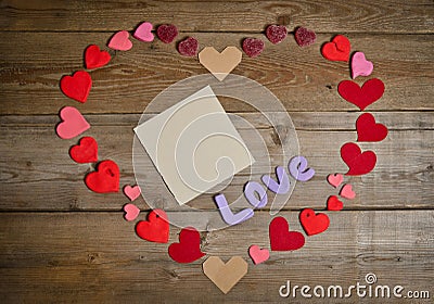 Word Love composition on the wooden board surface and many hearts Stock Photo