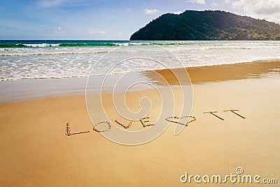 Word Love TT Trinidad and Tobago written on the beach sand in Maracas Bay Beach Stock Photo