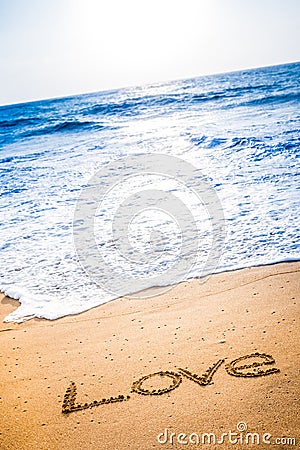 The word LOVE written in the sand Stock Photo