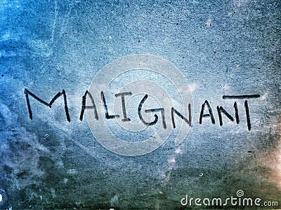 word malignant on the lite blue color paper page Stock Photo