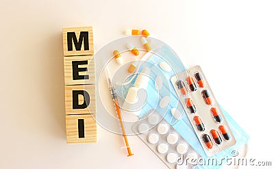 The word MEDI is made of wooden cubes on a white background. Medical concept Stock Photo