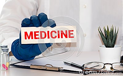 Word medicine with medical stethoscope, pills and notebook on a blue background. Medicine concept Stock Photo