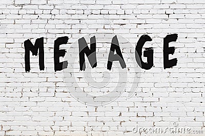 Word menage painted on white brick wall Stock Photo