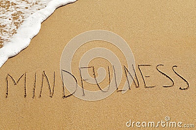 Word mindfulness in the sand Stock Photo