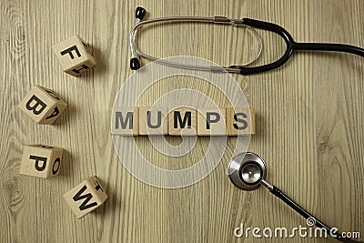 Word mumps from wooden blocks with stethoscope Stock Photo