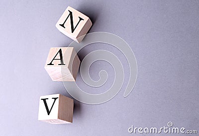 Word NAV on wooden block on the grey background Stock Photo