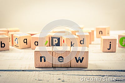 Word ` new ` wood Cubic on the wood Stock Photo