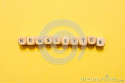 the word Newsletter, text made with dice on yellow background Stock Photo