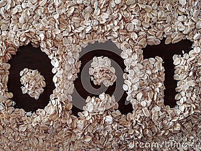 The word OAT surrounded by oat flakes Stock Photo