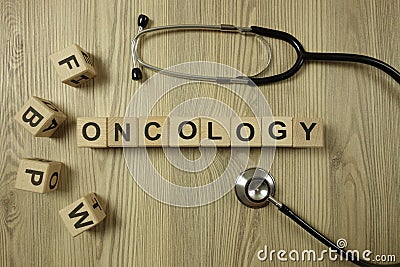 Word oncology from wooden blocks with stethoscope Stock Photo