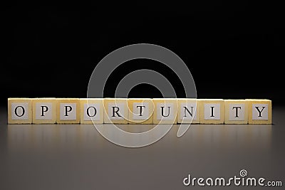 The word OPPORTUNITY written on wooden cubes isolated on a black background Stock Photo