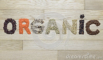 Word organic made of different seeds on a wooden background Stock Photo