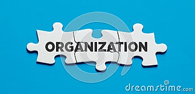 The word organization on connected jigsaw puzzle pieces. To organize in business Stock Photo