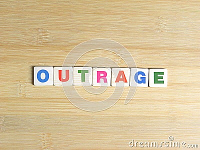 Word Outrage on wood background Stock Photo