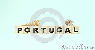 Word Portugal small wooden blocks and seashells on mint Stock Photo