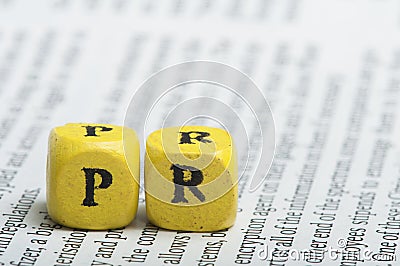 Word PR.Wooden cubes on magazine Stock Photo