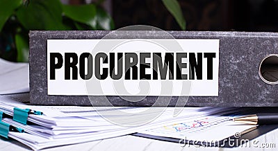 The word PROCUREMENT is written on a gray file folder next to documents. Business concept Stock Photo