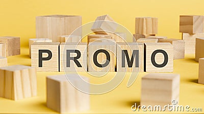 the word promo written on wooden cubes on yellow background Stock Photo