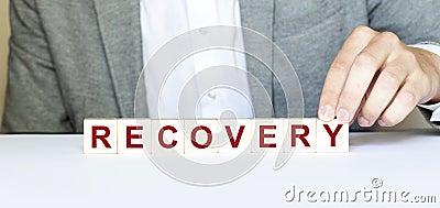 Word RECOVERY made with wood building blocks. New normal Stock Photo