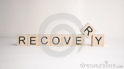 The word recovery is written on wooden cubes on a light background. Business concept Stock Photo