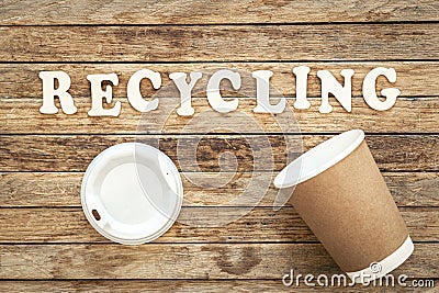 The word Recycling written on wood letters on wooden background, top view. Stock Photo