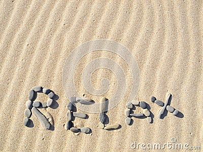 Word relax written in sand Stock Photo