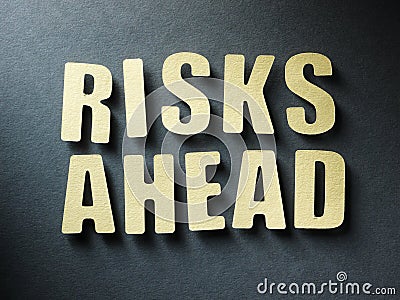 The word Risks Ahead on paper background Stock Photo