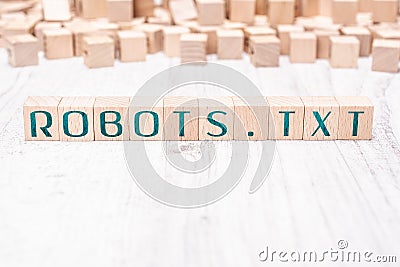 The Word Robots.txt Formed By Wooden Blocks On A White Table Stock Photo