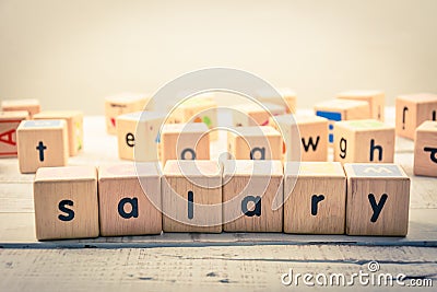 Word ` salary ` wood Cubic on the wood Stock Photo