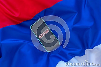 The word Sanctions on the Serbian flag. Aggravation of the Serbian and Kosovo conflict concept Stock Photo