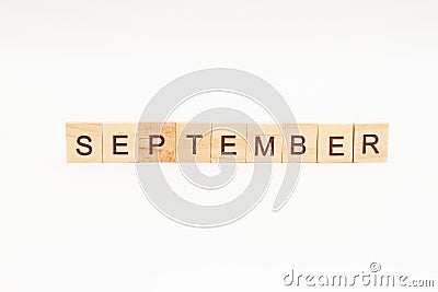 Word SEPTEMBER made of wooden blocks on white background. Month of year. First month of autumn Stock Photo