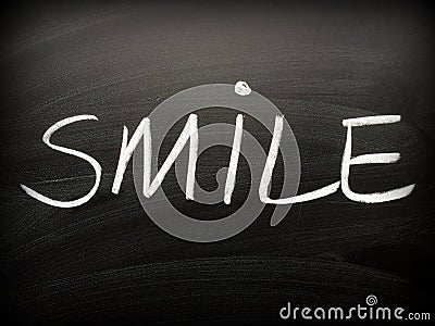 The word SMILE written on a Blackboard Stock Photo