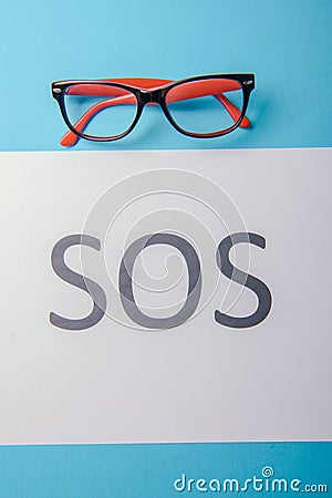 Word SOS written on paper Stock Photo