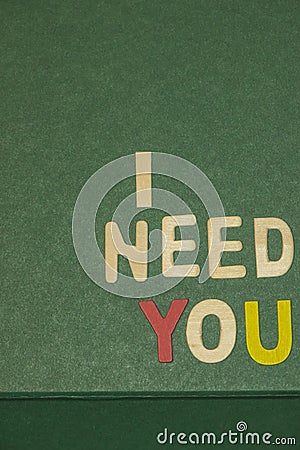 The word spelling to `I need you` on green background Stock Photo