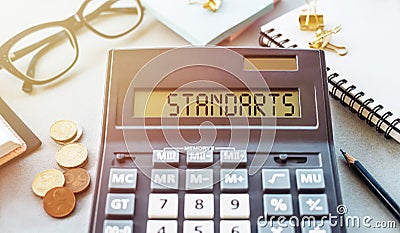 Word STANDARTS written on calculator on office table Stock Photo