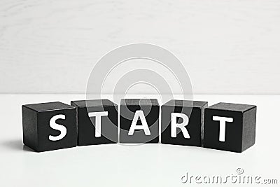 Word START made with black cubes on table, closeup Stock Photo