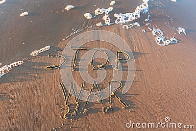 The word `stop war` on the sea sand, written with stick on the beach with foam Stock Photo