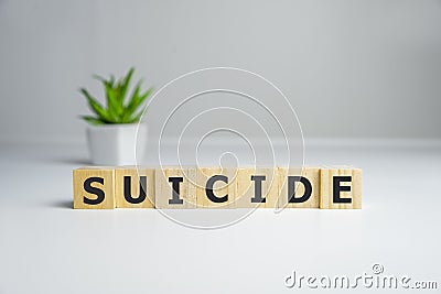 word suicide text spelled on wooden cubes, on white background Stock Photo