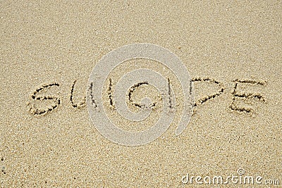 SUICIDE written on sand Stock Photo