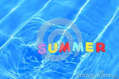 Word summer floating in a swimming pool Stock Photo