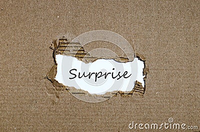 The word surprise appearing behind torn paper Stock Photo